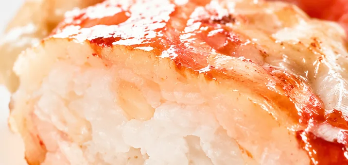Formed seafood portion cut open to show a cohesive, springy interior